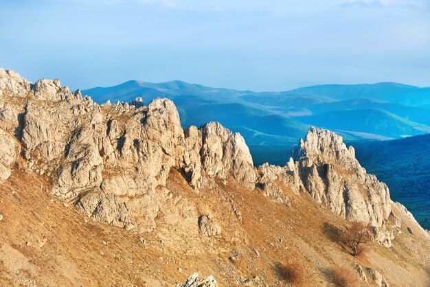 Sunset in the mountains with rocks and green grass