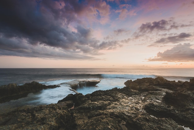 Sunset over the ocean and rocks ocean landscape