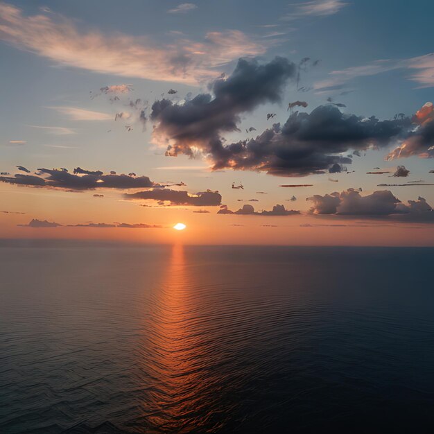 Photo a sunset over the ocean with a sun setting behind the clouds