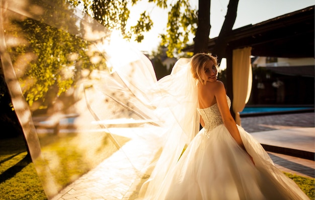 Sunset portrait of smiling bride. happy gorgeous bride smiling in the evening warm sunlight.