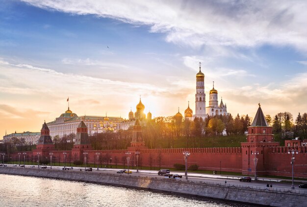 The sunset rays of the sun over the towers and churches of the Moscow Kremlin