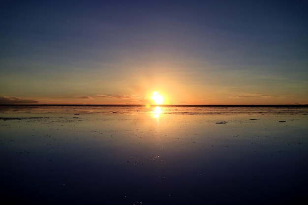 Sunset reflection on the flooded Uyuni Salt Flats UNESCO World Heritage Site in Bolivia