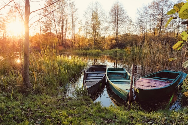 Sunset on the river in the fall with boats