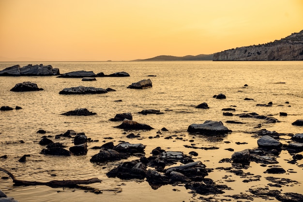 Sunset at rocky beach