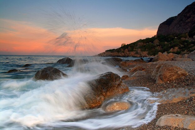 Sunset on the rocky shore of tropical sea Summer vacation on tropical resort