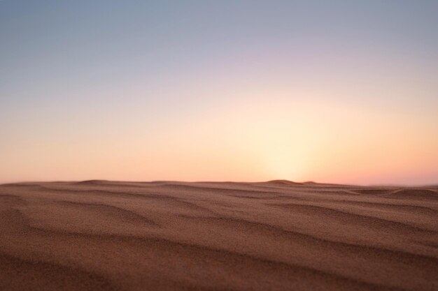 砂漠の砂丘に沈む夕日