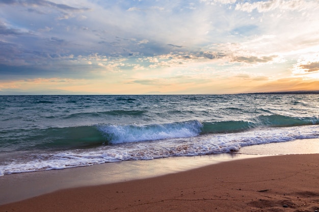 Sunset on the sea, beautiful mountains and clouds