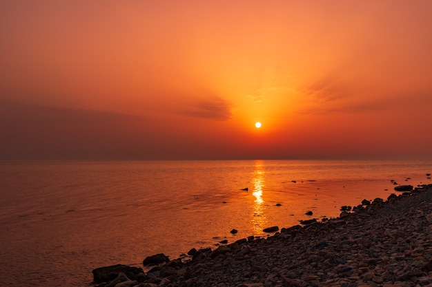 Sunset over the sea horizon