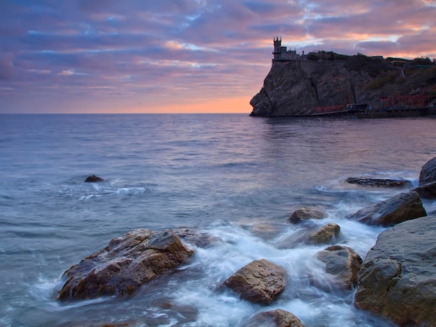 Sunset on the sea near the fairytale castle