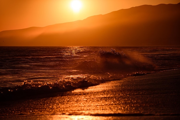 Sunset over sea with golden dramatic sky panorama calm sea with sunset sky ocean and sky background