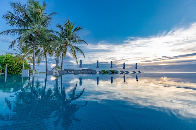 Sunset swimming pool reflection, tranquil leisure poolside, exotic tropical beach landscape.