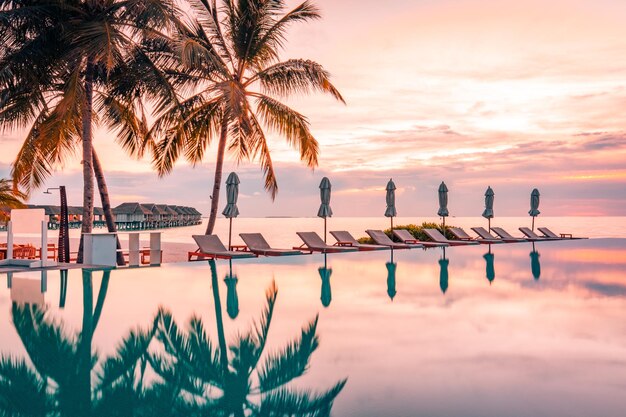 Sunset swimming pool reflection, tranquil leisure poolside, exotic tropical beach landscape.