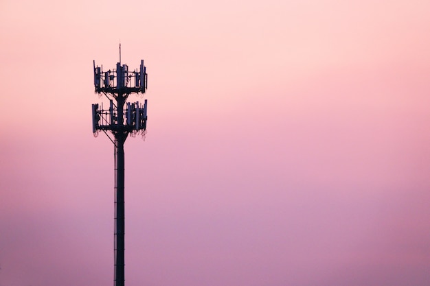 Photo sunset and tall mast with cellular antenna