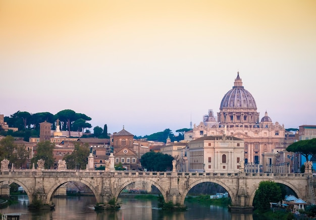 Sunset on Tiber river bridge with Vatican City Rome Italy