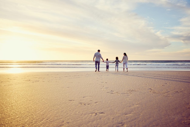 Sunset travel and family holding hands on beach walking on holiday summer vacation and weekend Nature mockup and mother father and children by ocean for bonding adventure and quality time