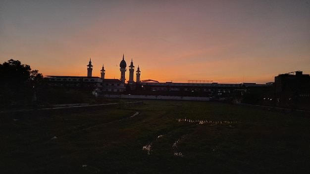 A sunset view of the mosque from the field