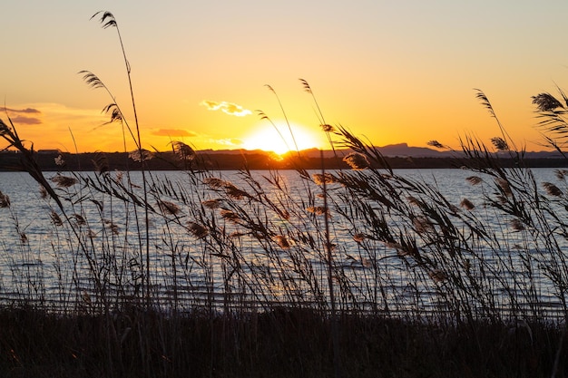 Sunset over the water with mountains in the background