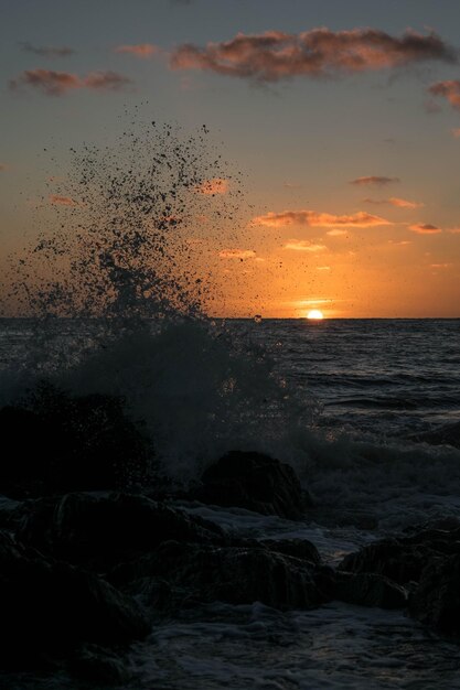 Foto il tramonto dietro l'onda