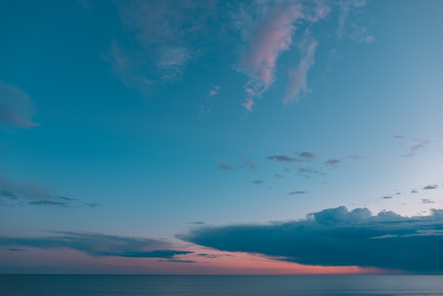 Photo sunset with clouds and turquoise blue and orange sky with the sea