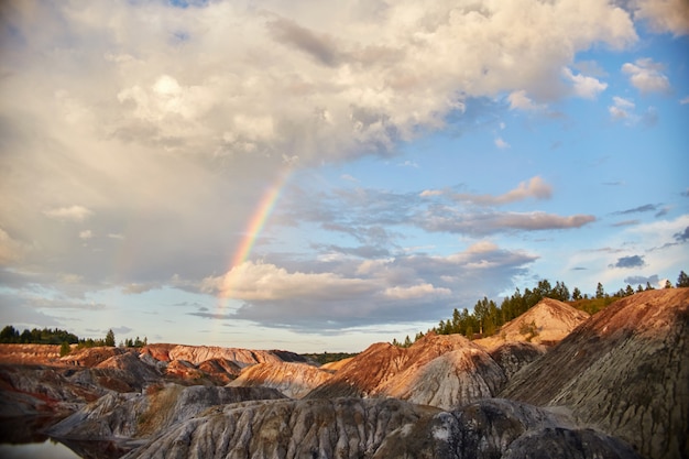 Sunset with a rainbow in the sand hills. fairytale