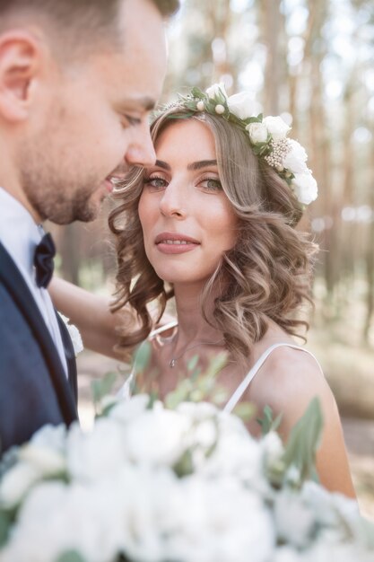 Sunshine portrait of happy bride and groom outdoor in nature