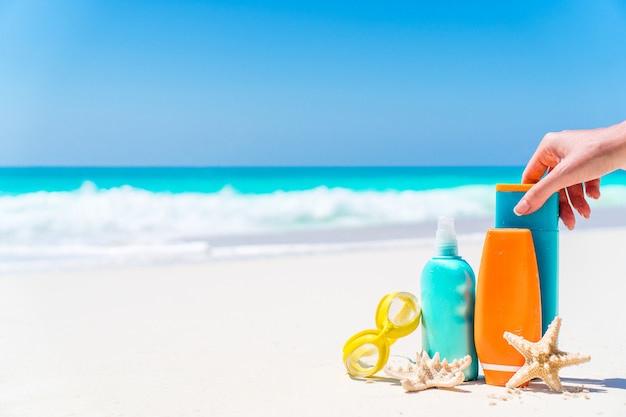 Suntan lotion bottles and starfish at the beach