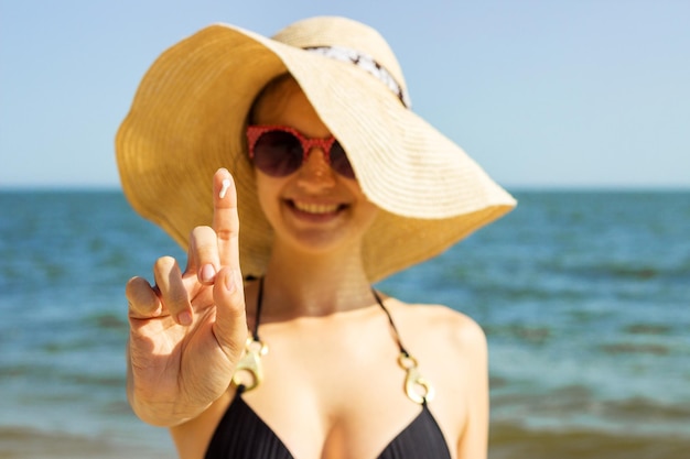 Suntan lotion woman applying sunscreen solar cream Beautiful happy cute woman applying suntan cream Sunscreen on the finger