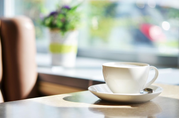 Sup of coffee on table in cafe Morning light