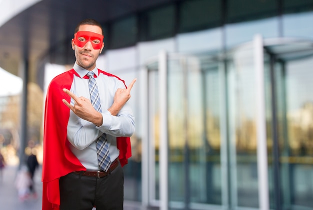 Super businessman doing a rock gesture