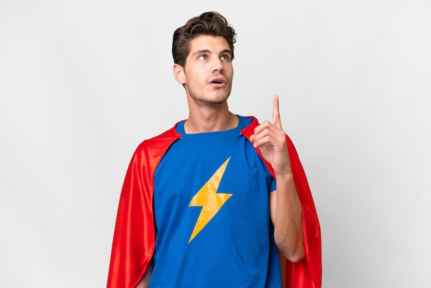 Super Hero caucasian man over isolated white background thinking an idea pointing the finger up