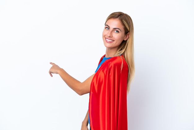 Super Hero caucasian woman isolated background pointing back