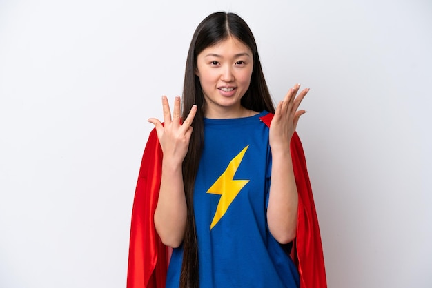 Super Hero Chinese woman isolated on white background counting nine with fingers