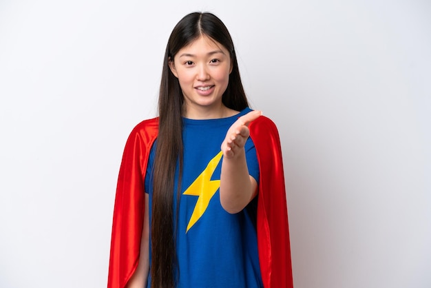 Super Hero Chinese woman isolated on white background shaking hands for closing a good deal