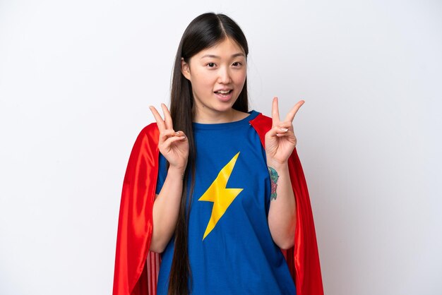 Super Hero Chinese woman isolated on white background showing victory sign with both hands