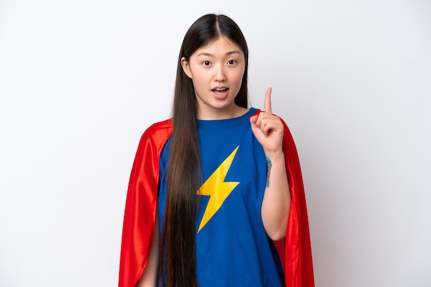 Super hero chinese woman isolated on white background thinking\
an idea pointing the finger up