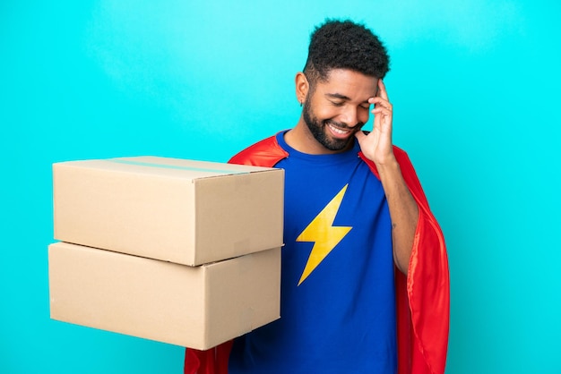 Super Hero delivery Brazilian man isolated on blue background laughing