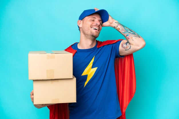 Photo super hero delivery man over isolated background has realized something and intending the solution