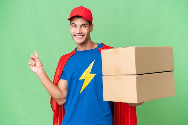 Super Hero delivery man over isolated background pointing finger to the side