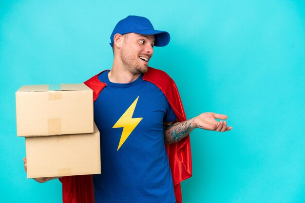 Photo super hero delivery man over isolated background with surprise expression while looking side