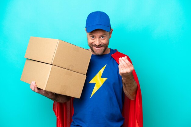 Super Hero delivery man isolated on blue background making money gesture