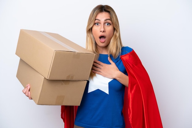 Super Hero delivery woman isolated on white background surprised and shocked while looking right