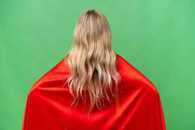 Super Hero English woman over isolated background in back position