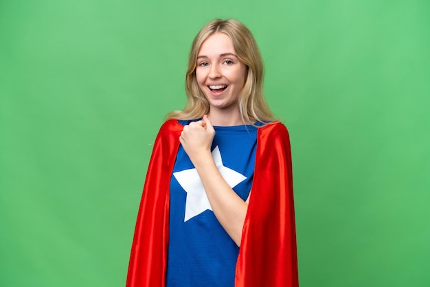Photo super hero english woman over isolated background celebrating a victory