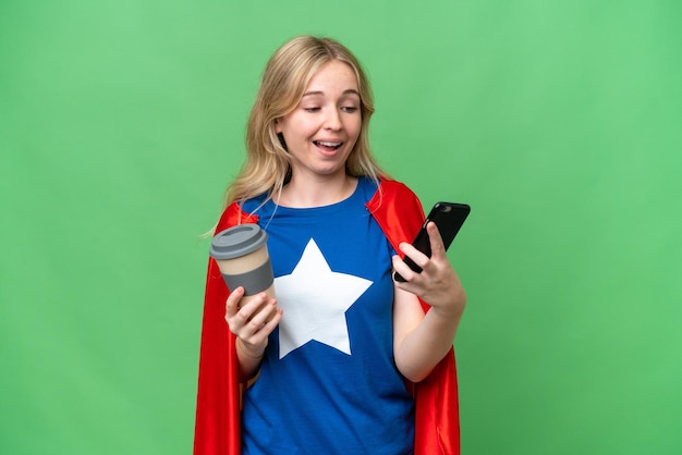 Super Hero English woman over isolated background holding coffee to take away and a mobile