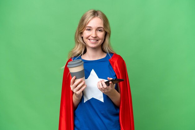 Super Hero English woman over isolated background holding coffee to take away and a mobile