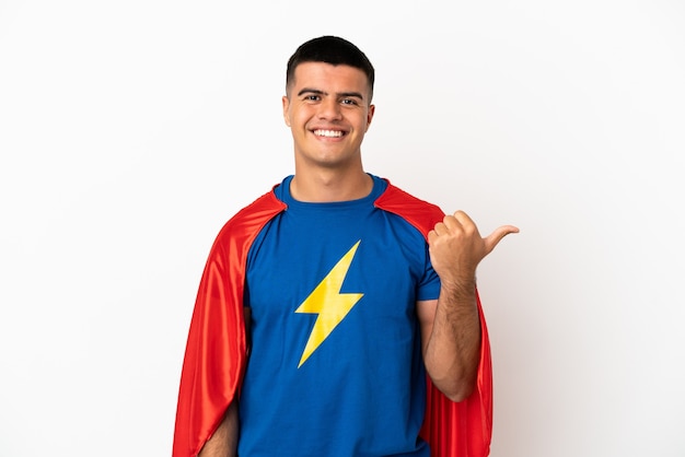 Super Hero over isolated white background pointing to the side to present a product
