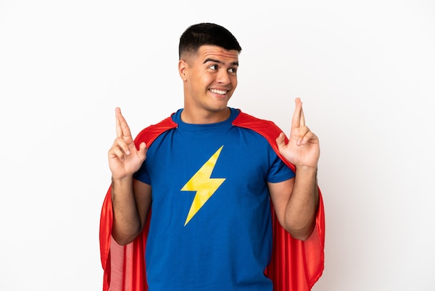 Super Hero over isolated white background with fingers crossing
