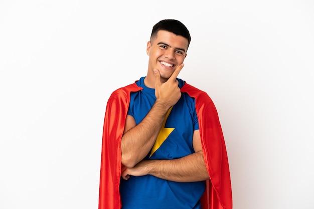 Super Hero over isolated white wall smiling