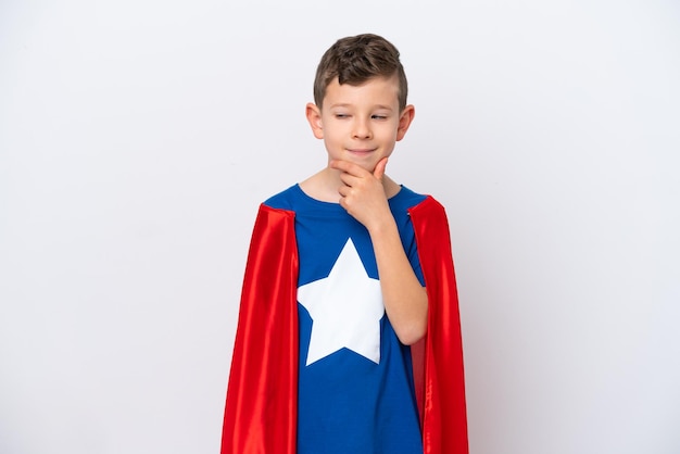 Super Hero little boy isolated on white background looking to the side and smiling