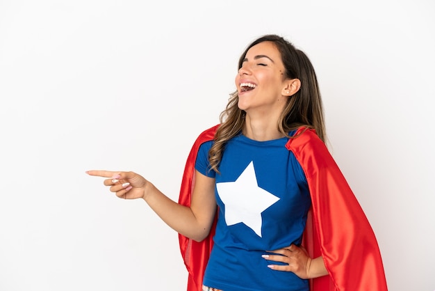 Super Hero woman over isolated white background pointing finger to the side and presenting a product